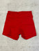 Red shorts on a light wooden surface