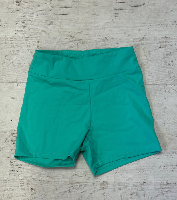 Teal shorts on a textured gray surface