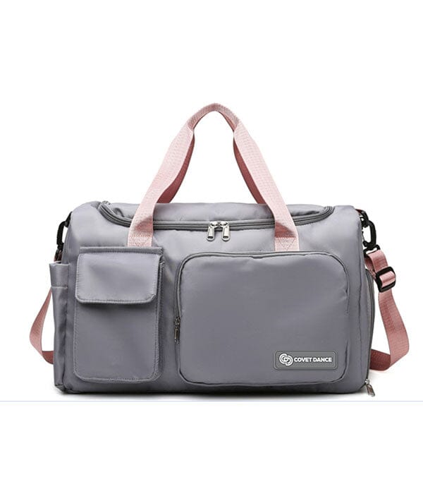 Gray duffel bag with pink straps on a white background