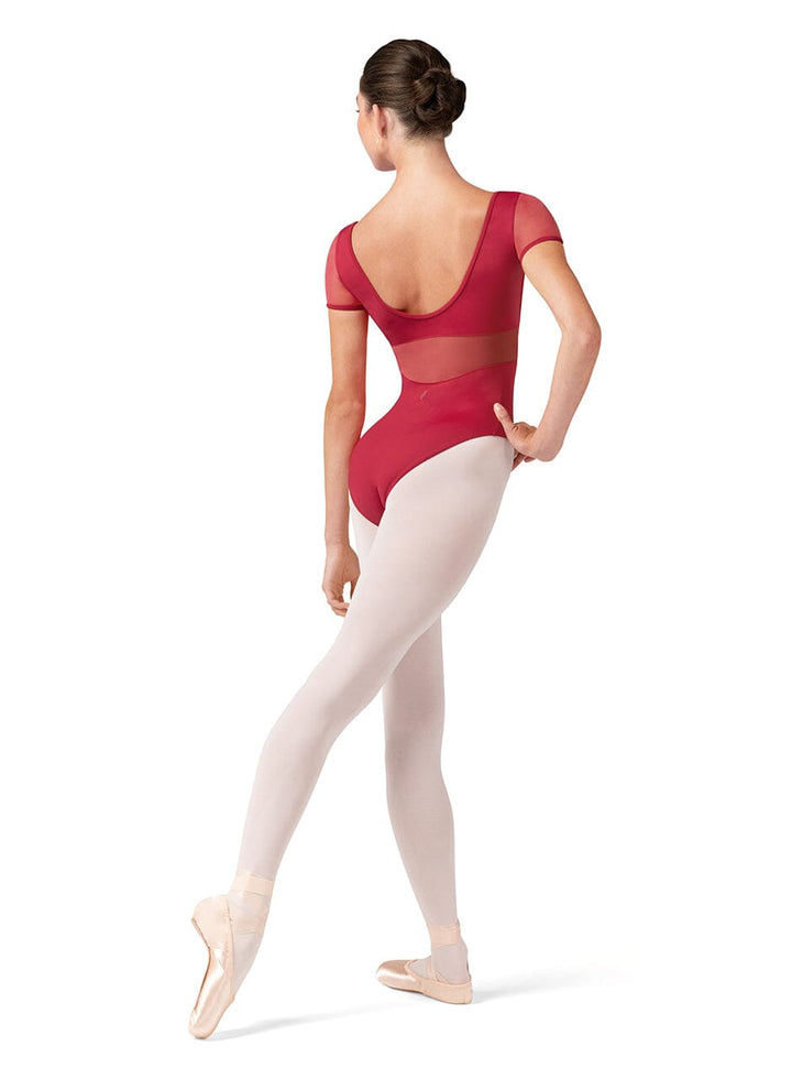 Ballerina in a red leotard and white tights on a white background