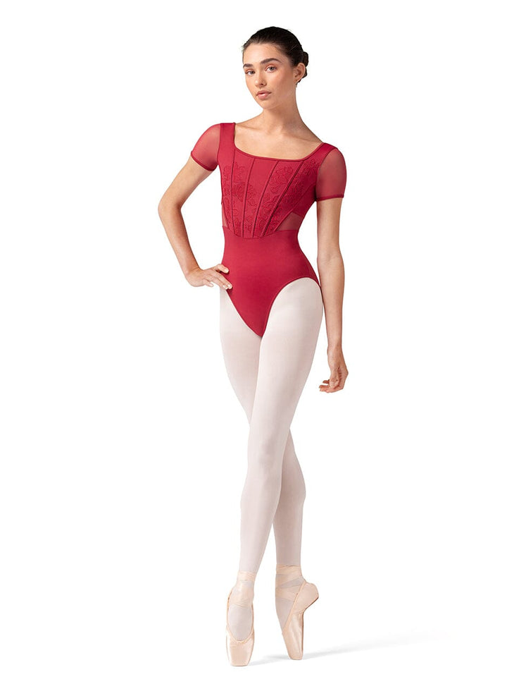 Ballerina in a red leotard and white tights on a white background