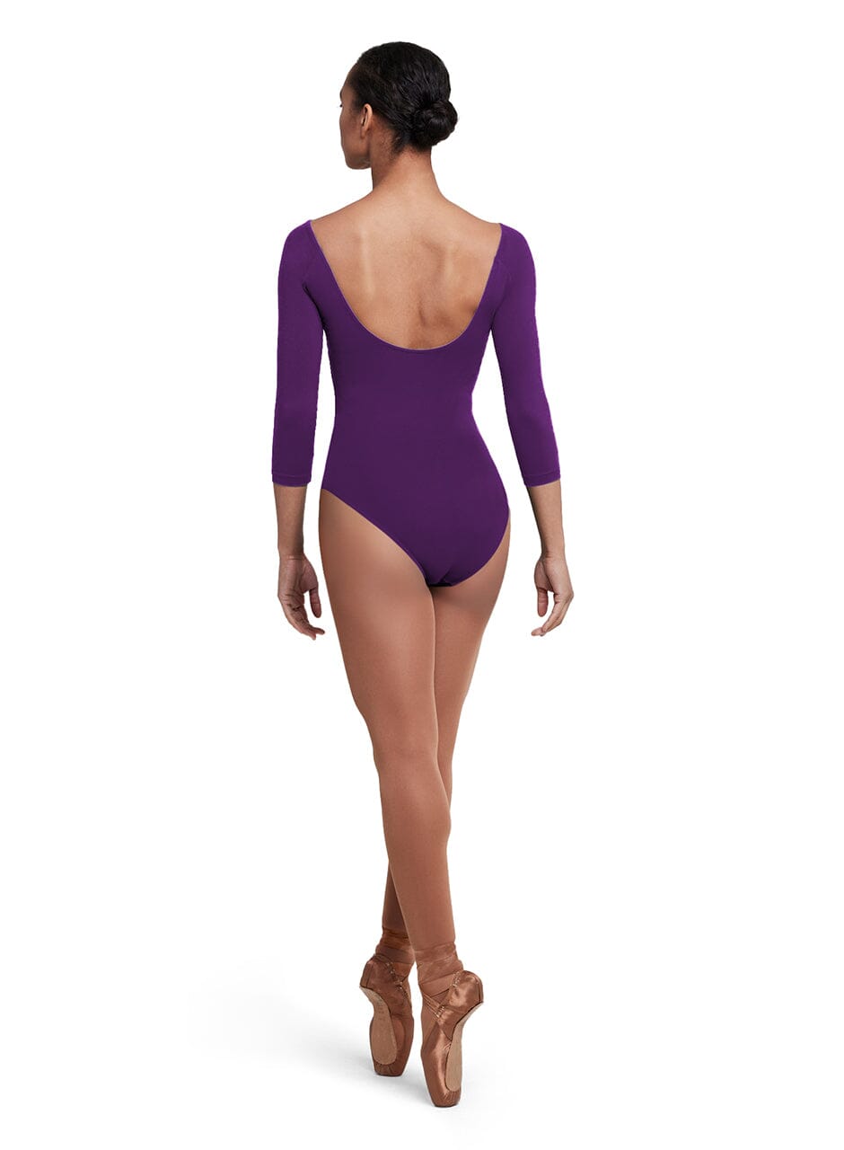 Person wearing a purple leotard on a white background