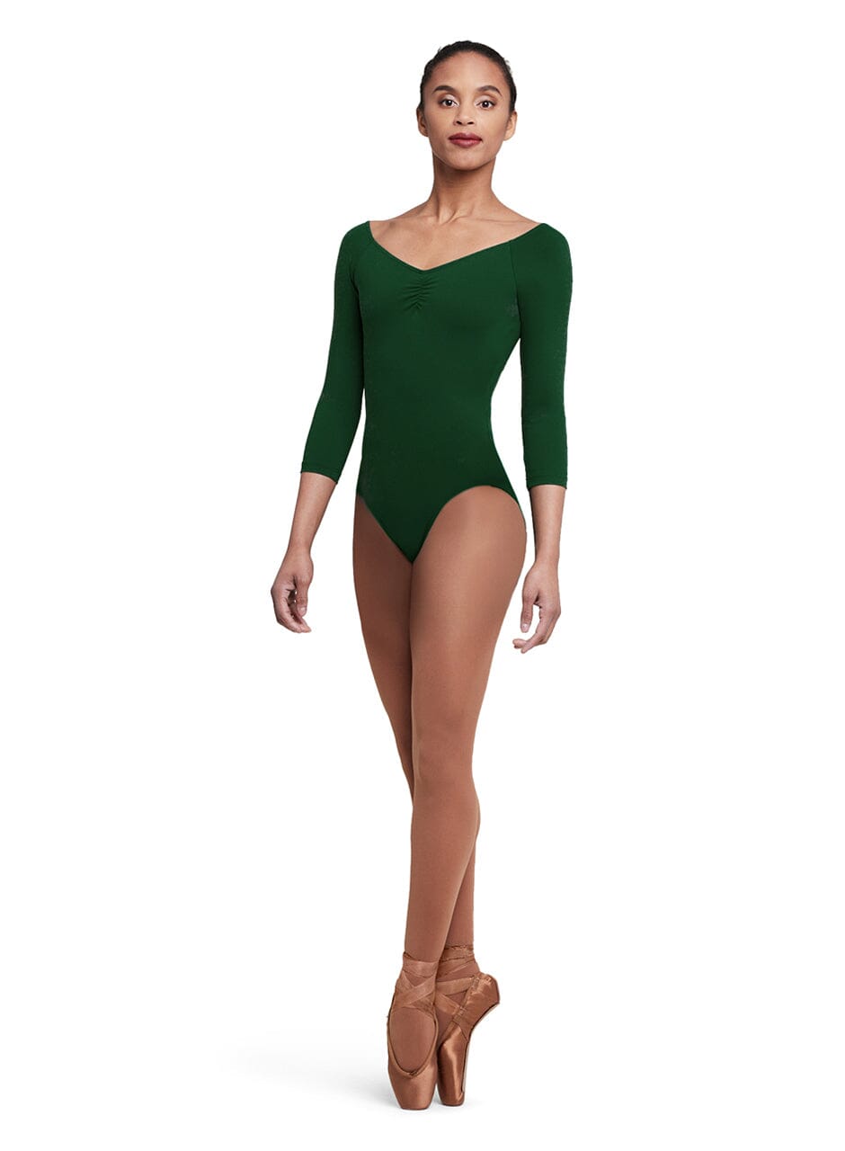 Person wearing a green leotard and brown tights on a white background