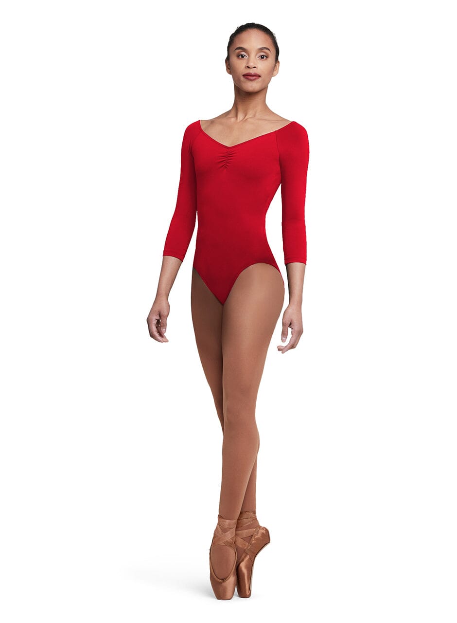 Dancer wearing a red leotard and brown tights on a white background