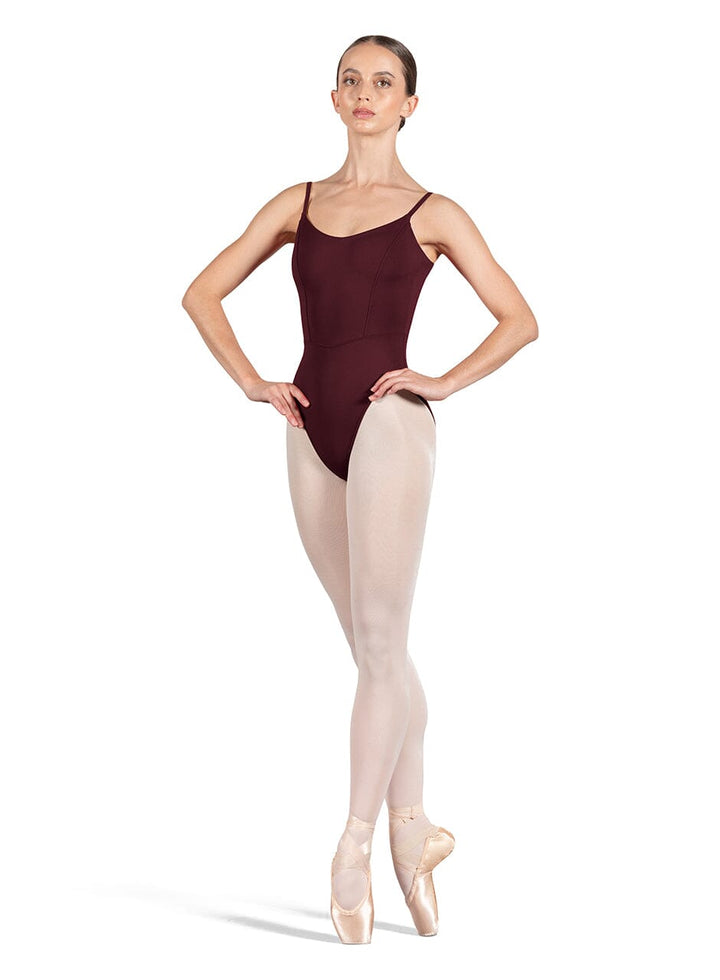 Ballerina in a burgundy leotard and beige tights on a white background