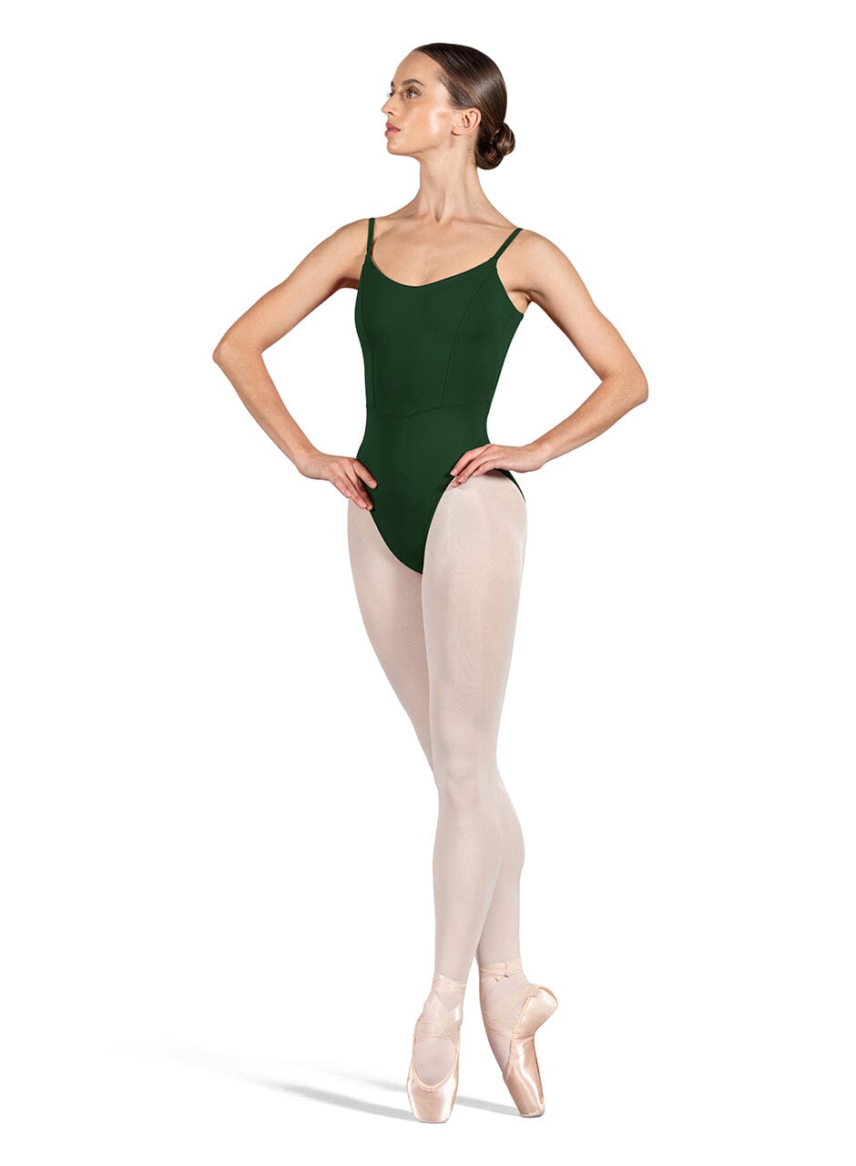 Ballerina in a green leotard and beige tights on a white background