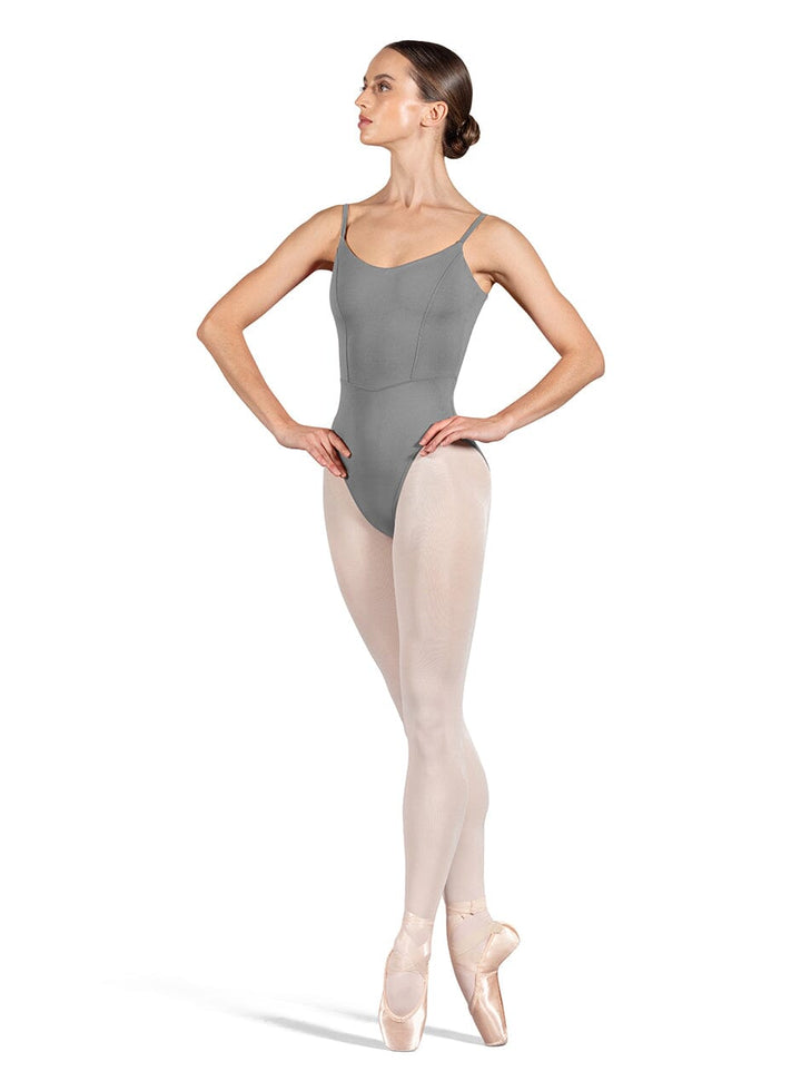 Ballerina in gray leotard and beige tights on a white background
