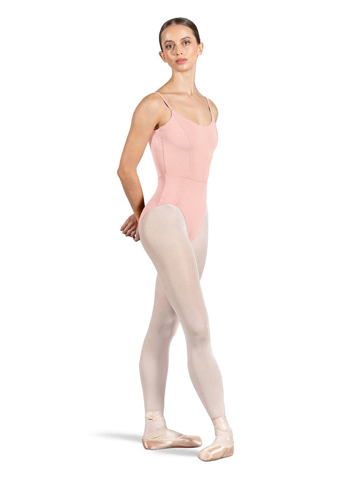 Ballerina wearing a pink leotard and beige tights on a white background