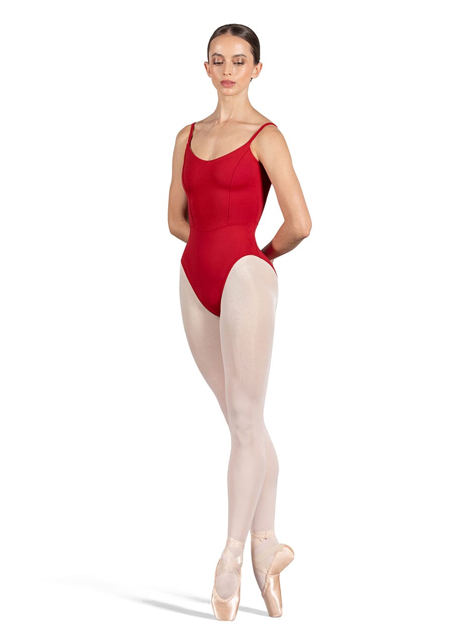 Ballerina wearing a red leotard and beige tights on a white background