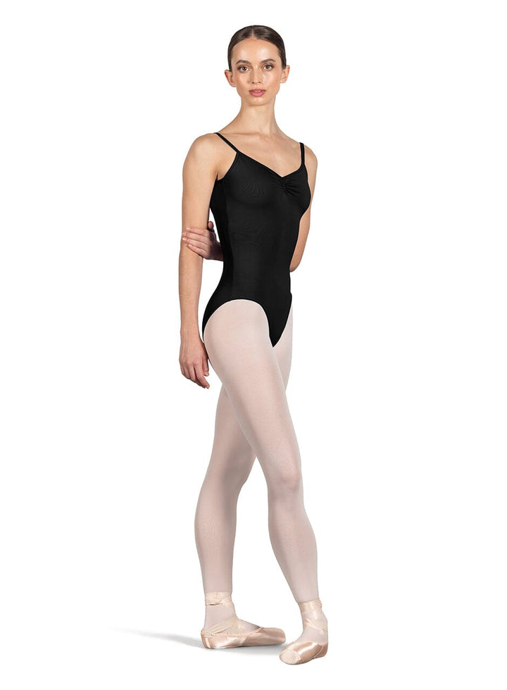 Ballerina wearing a black leotard and beige tights on a white background