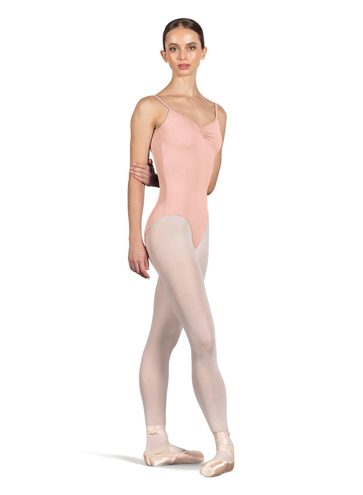 Ballerina wearing a pink leotard and beige tights on a white background