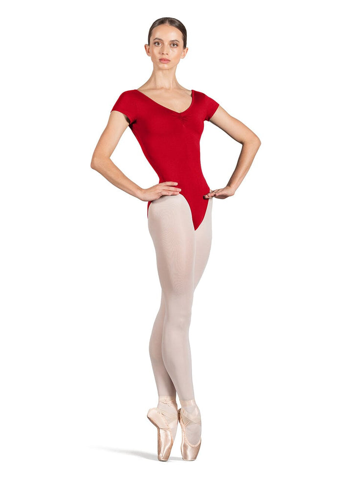 Ballerina in a red leotard and beige tights on a white background