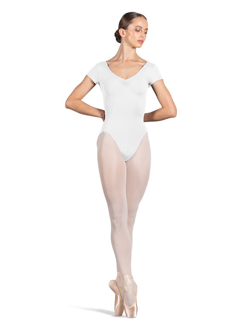 Ballerina in a white leotard and beige tights on a white background