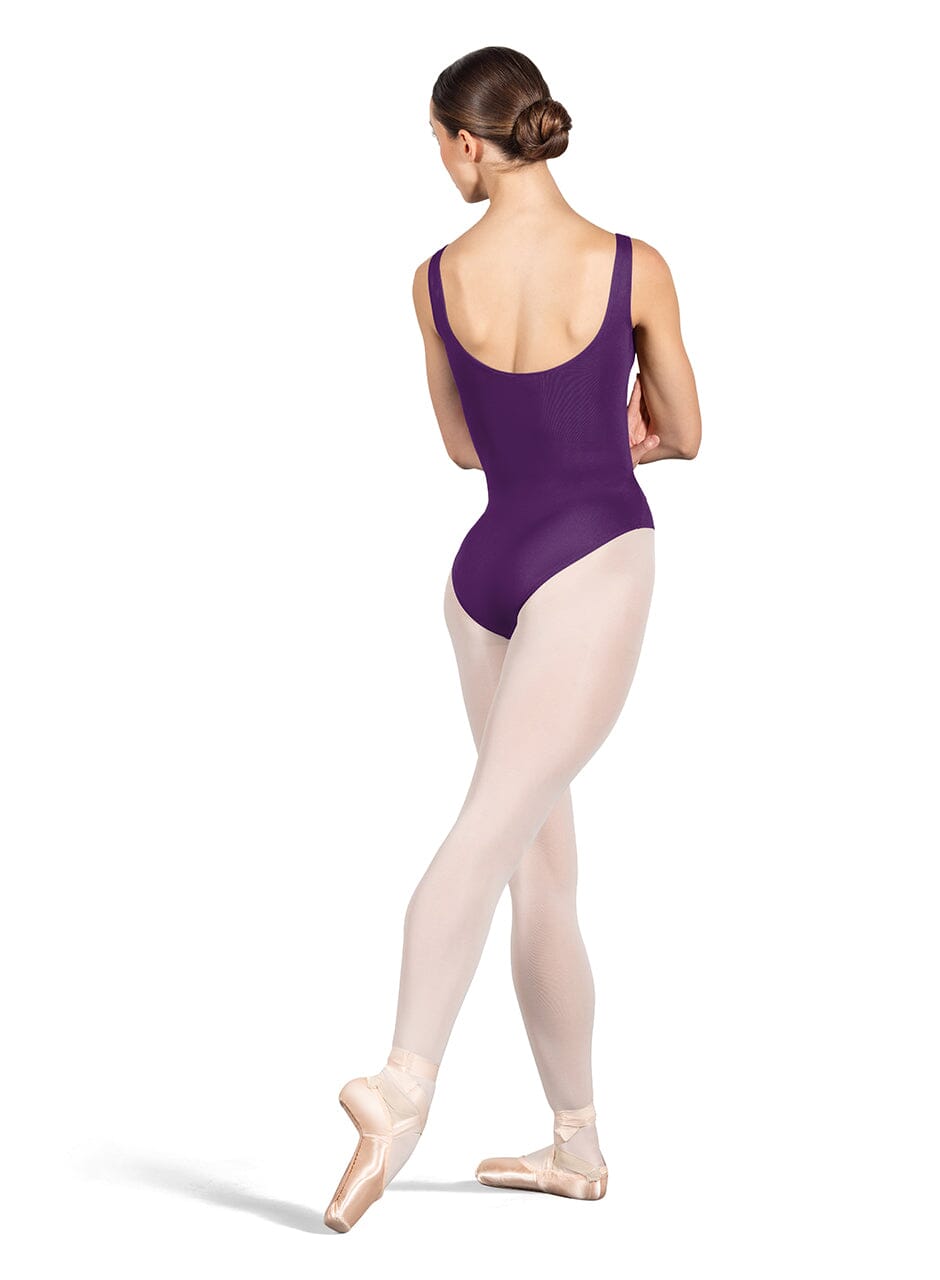 Ballerina in a purple leotard and beige tights on a white background
