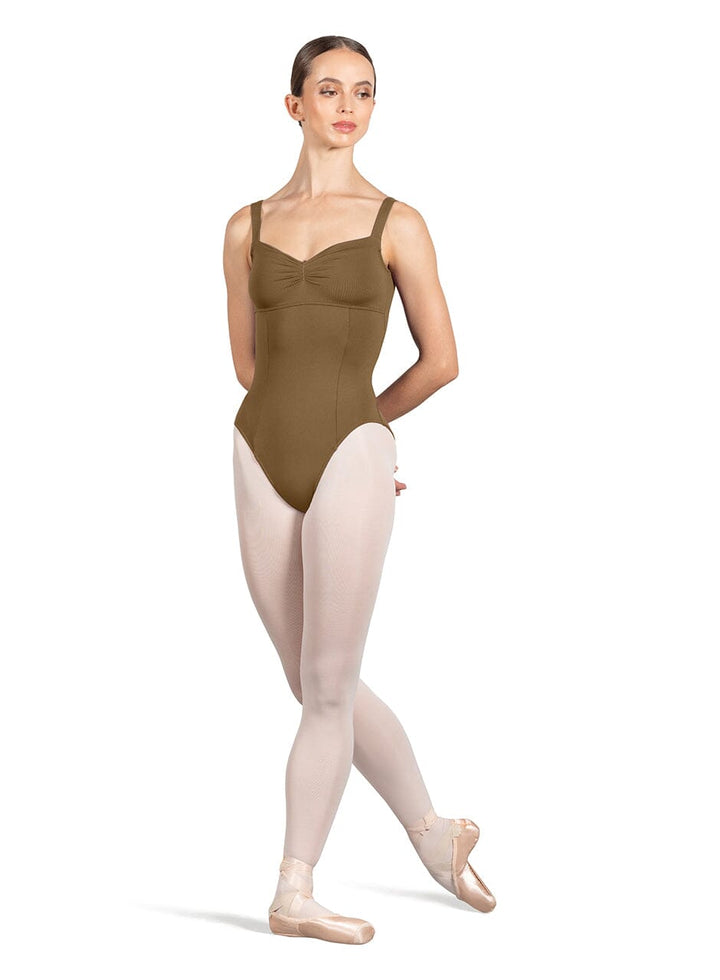 Ballerina in a brown leotard and pink tights on a white background
