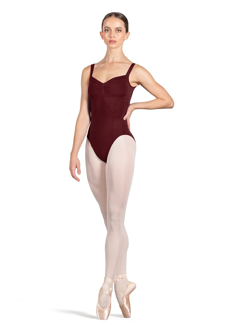 Ballerina in a burgundy leotard and white tights on a white background