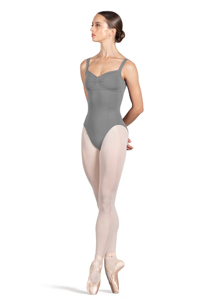Ballerina in a gray leotard and pink tights on a white background