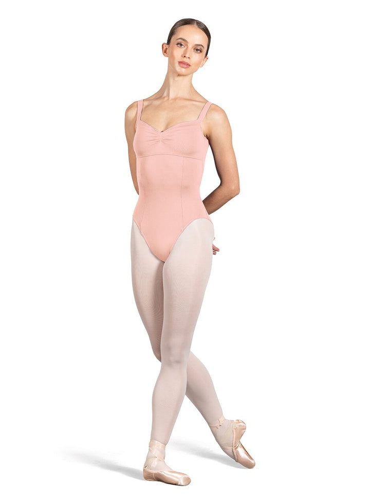 Ballerina in a pink leotard and tights on a white background