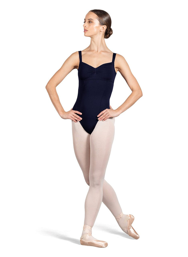 Ballerina in a navy leotard and pink tights on a white background