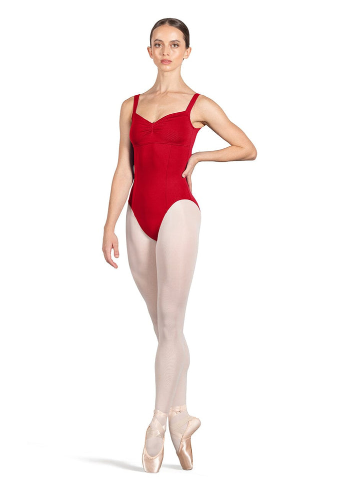 Ballerina in a red leotard and white tights on a white background