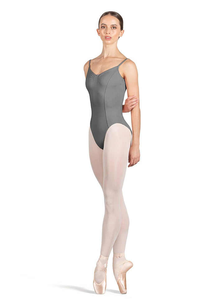 Ballerina wearing a gray leotard and beige tights on a white background