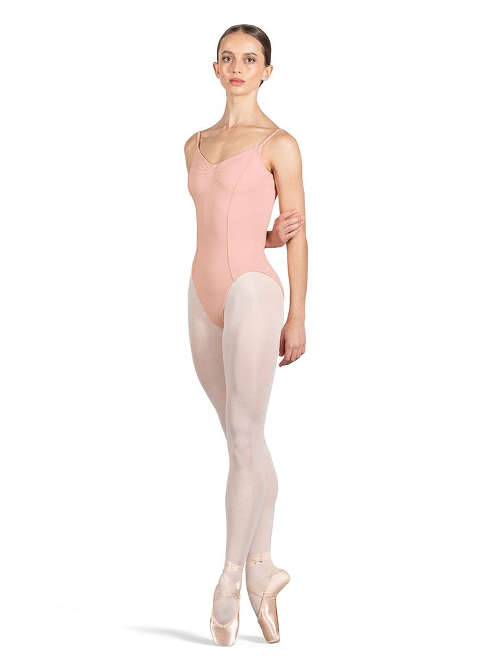 Ballerina wearing a pink leotard and beige tights on a white background