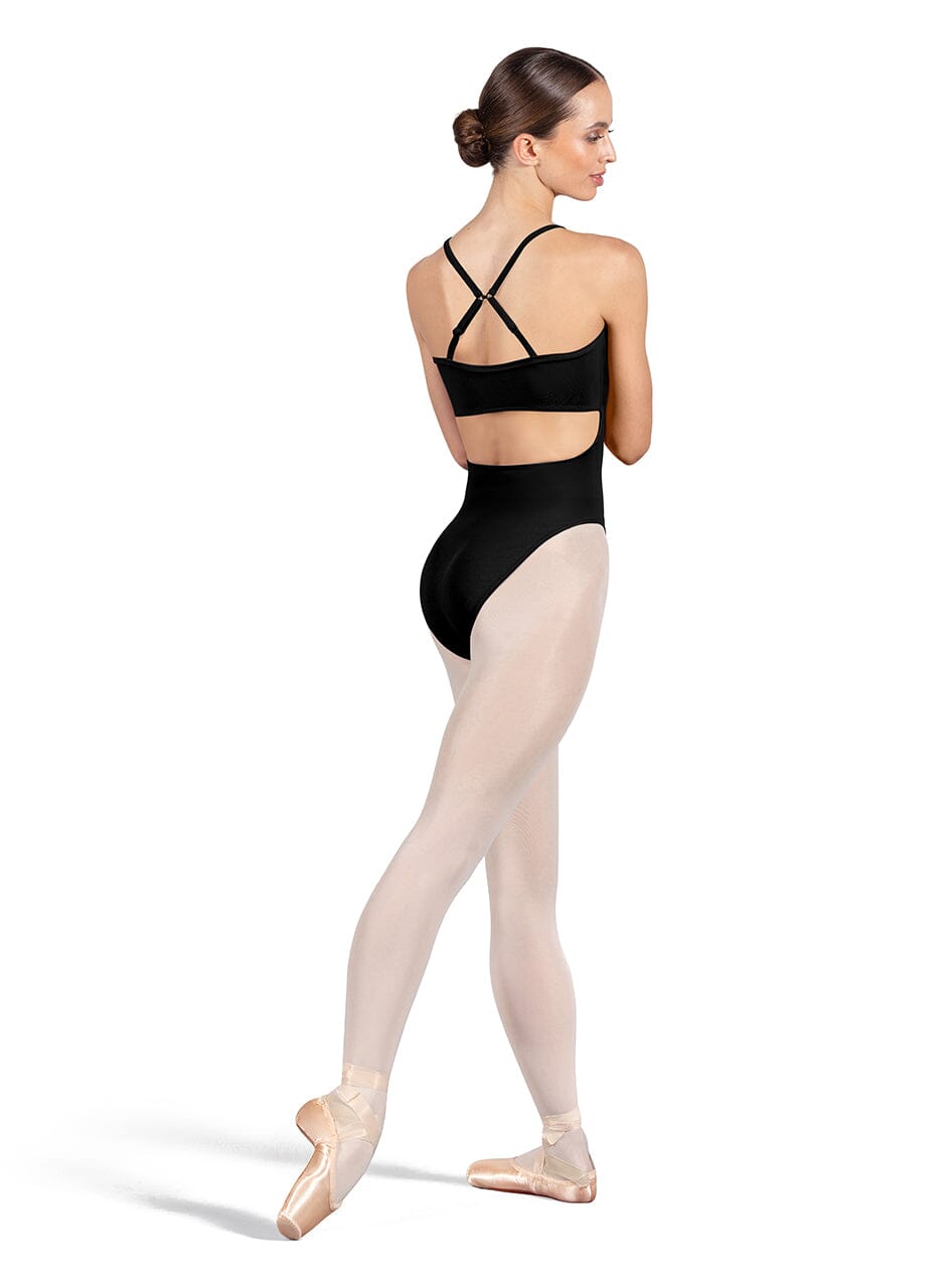 Ballet dancer in a black leotard and beige tights on a white background