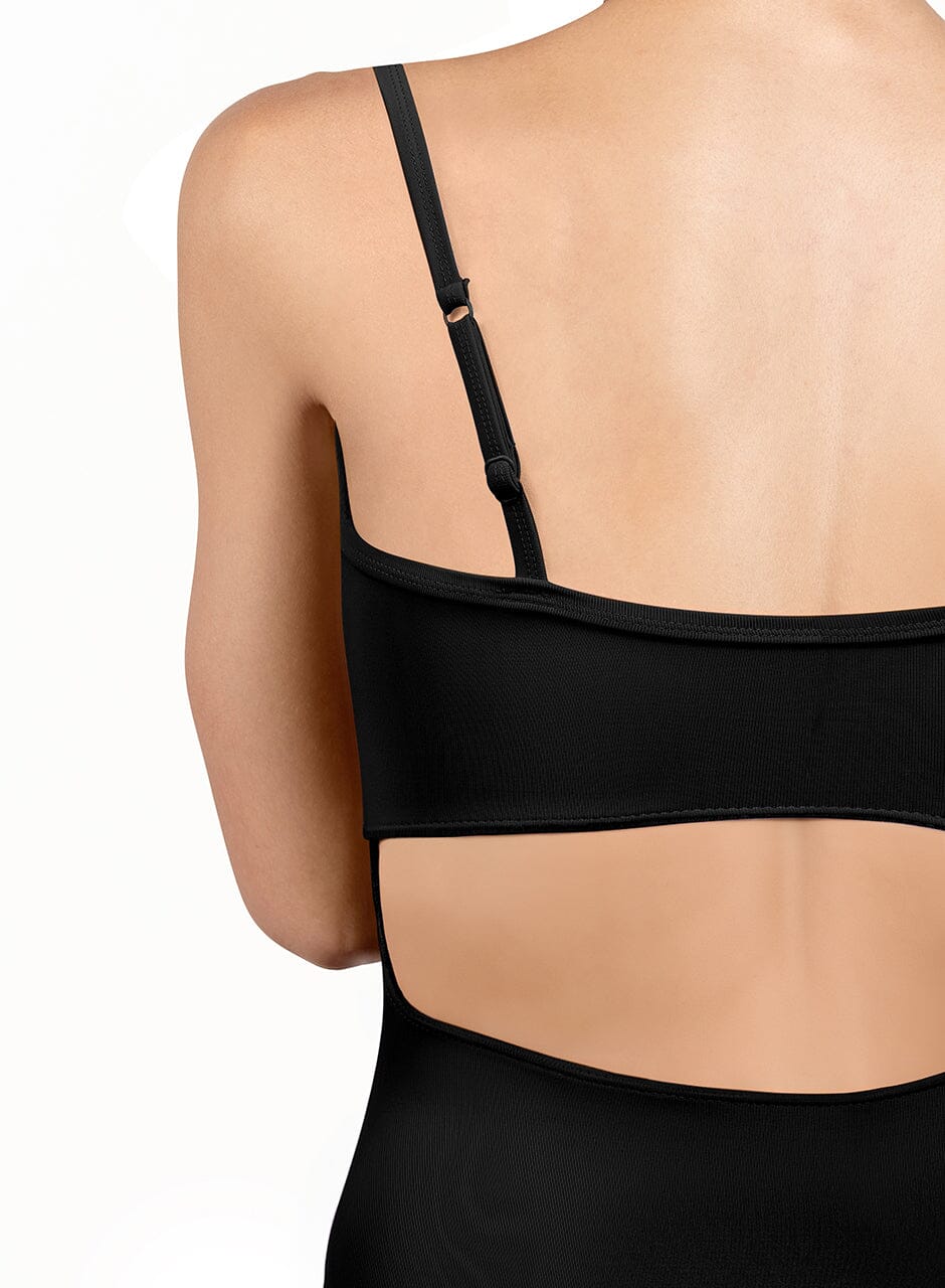 Black bra worn by a person on a white background