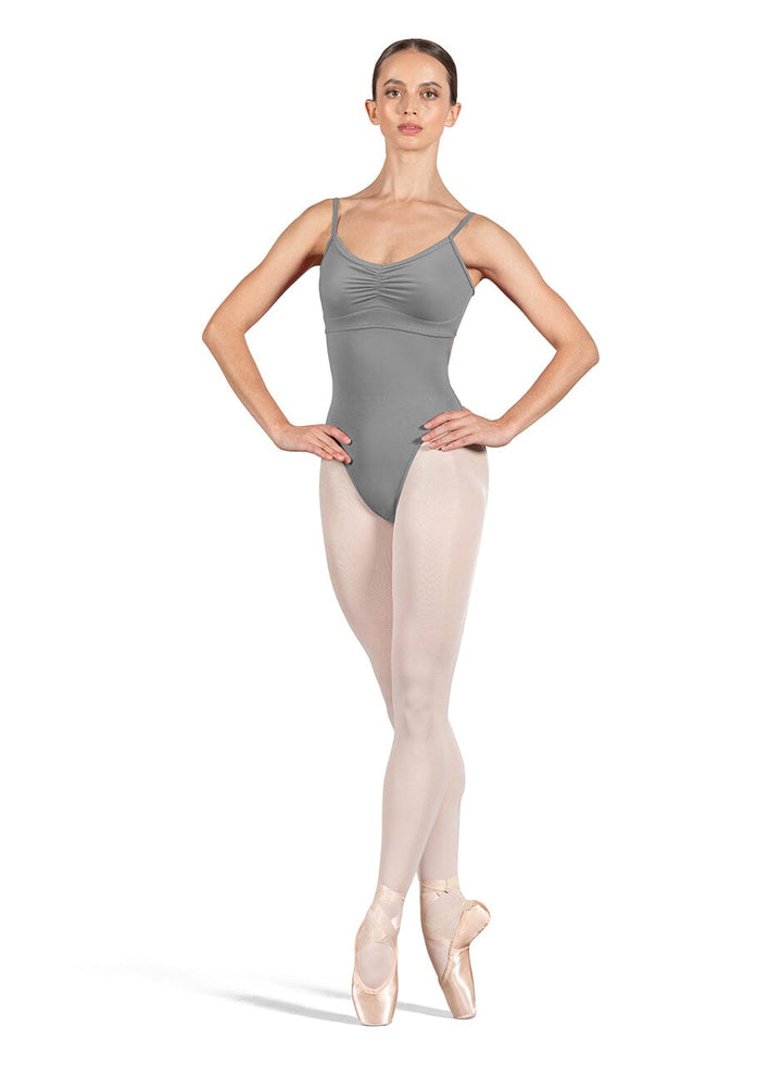 Ballerina in gray leotard and beige tights on a white background