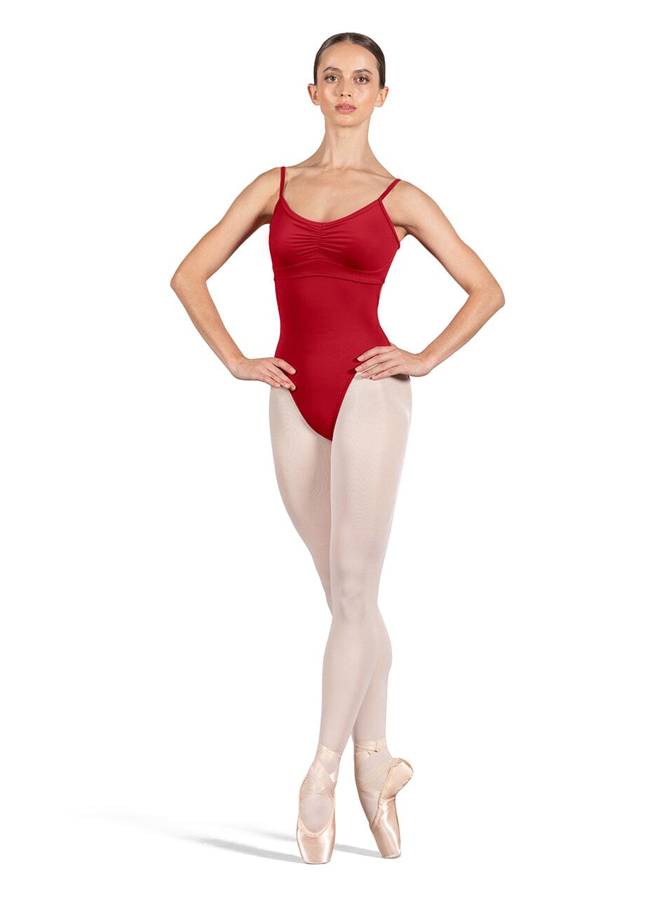 Dancer in a red leotard and beige tights on a white background