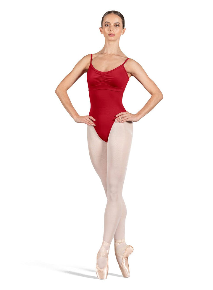 Dancer in a red leotard and beige tights on a white background