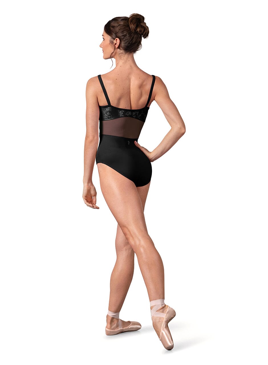 Woman wearing a black leotard with sheer mesh panels on a white background