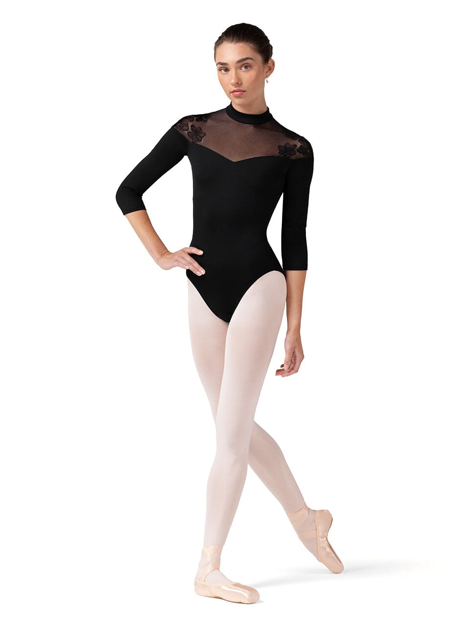 Dancer wearing a black leotard with sheer mesh panels on a white background