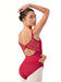 Woman wearing a red leotard with floral lace details on a white background