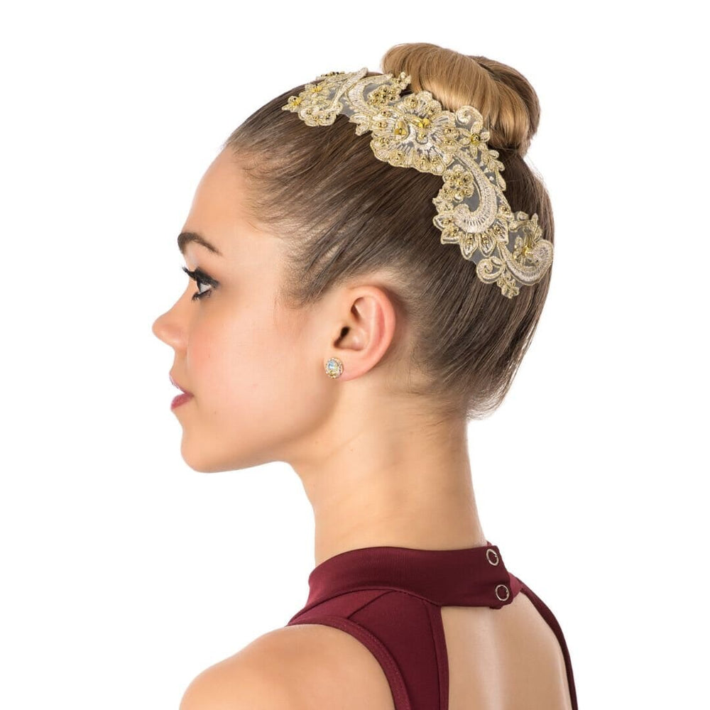 Woman wearing a decorative headband with a plain background