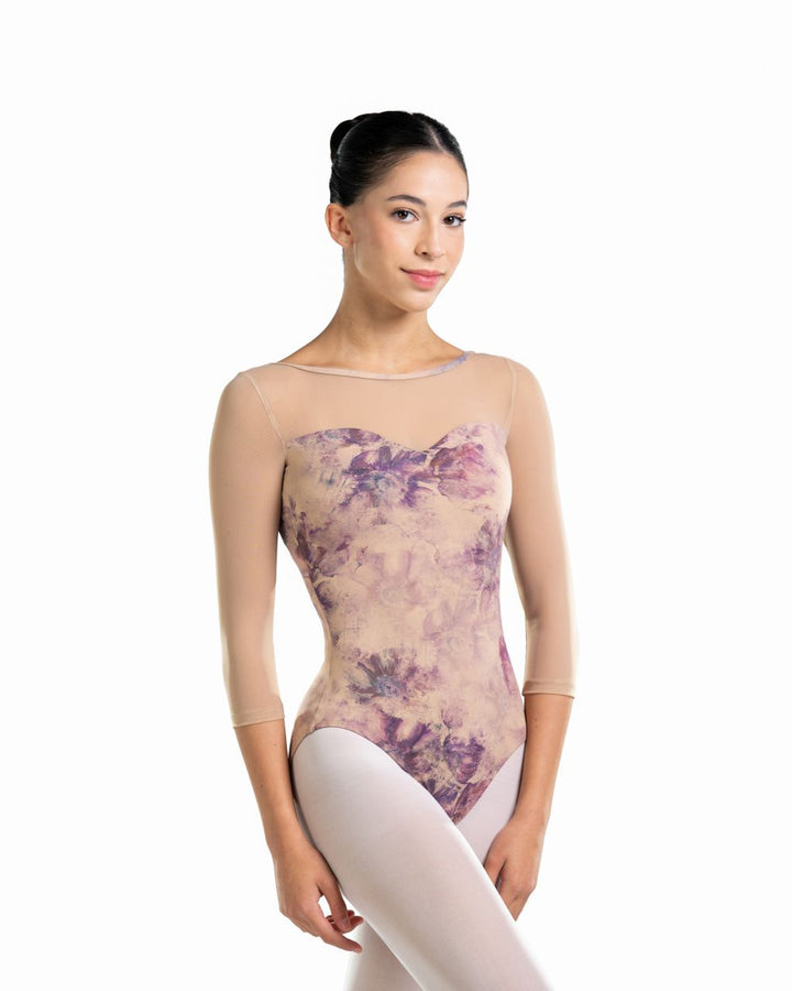 Woman wearing a floral-patterned leotard on a white background