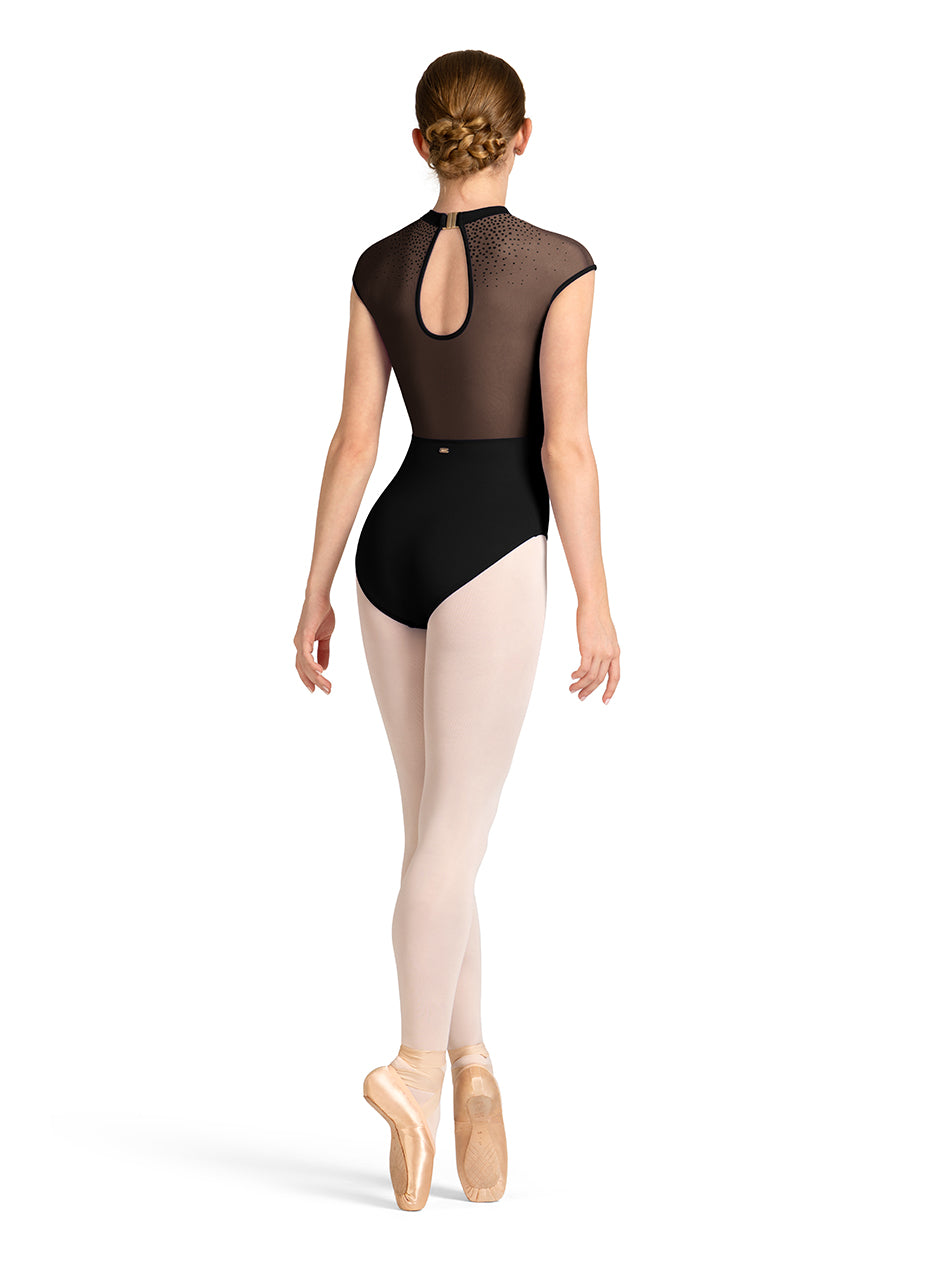 Ballerina in a black leotard and beige tights on a white background