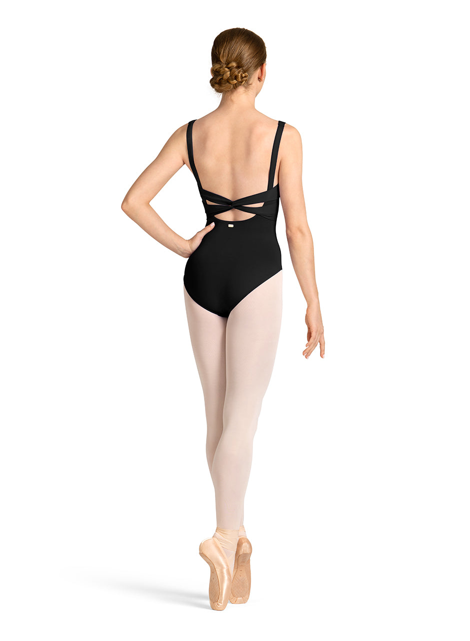 Ballet dancer wearing a black leotard with cut-out design on a white background