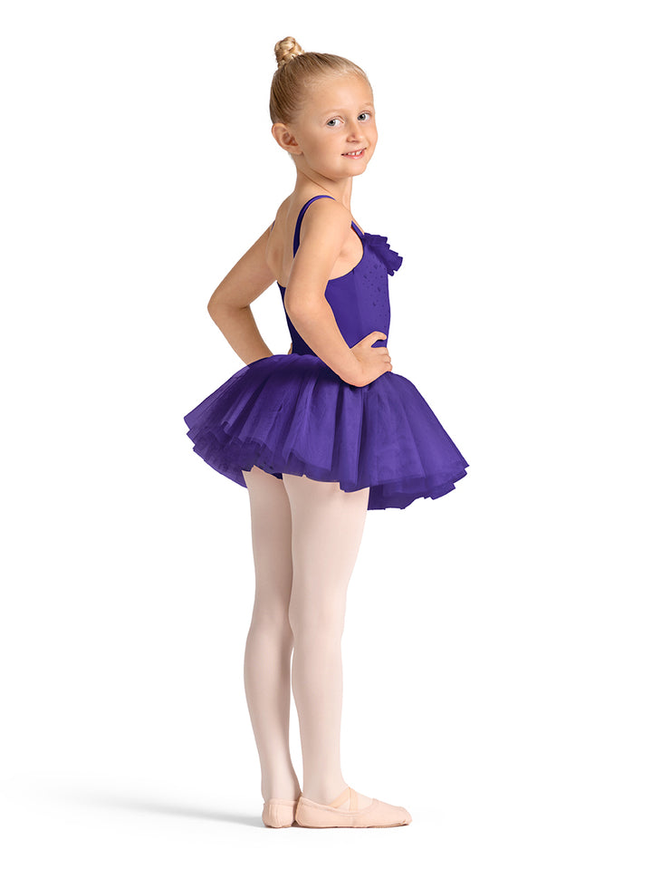 Young girl in a purple ballet outfit on a white background