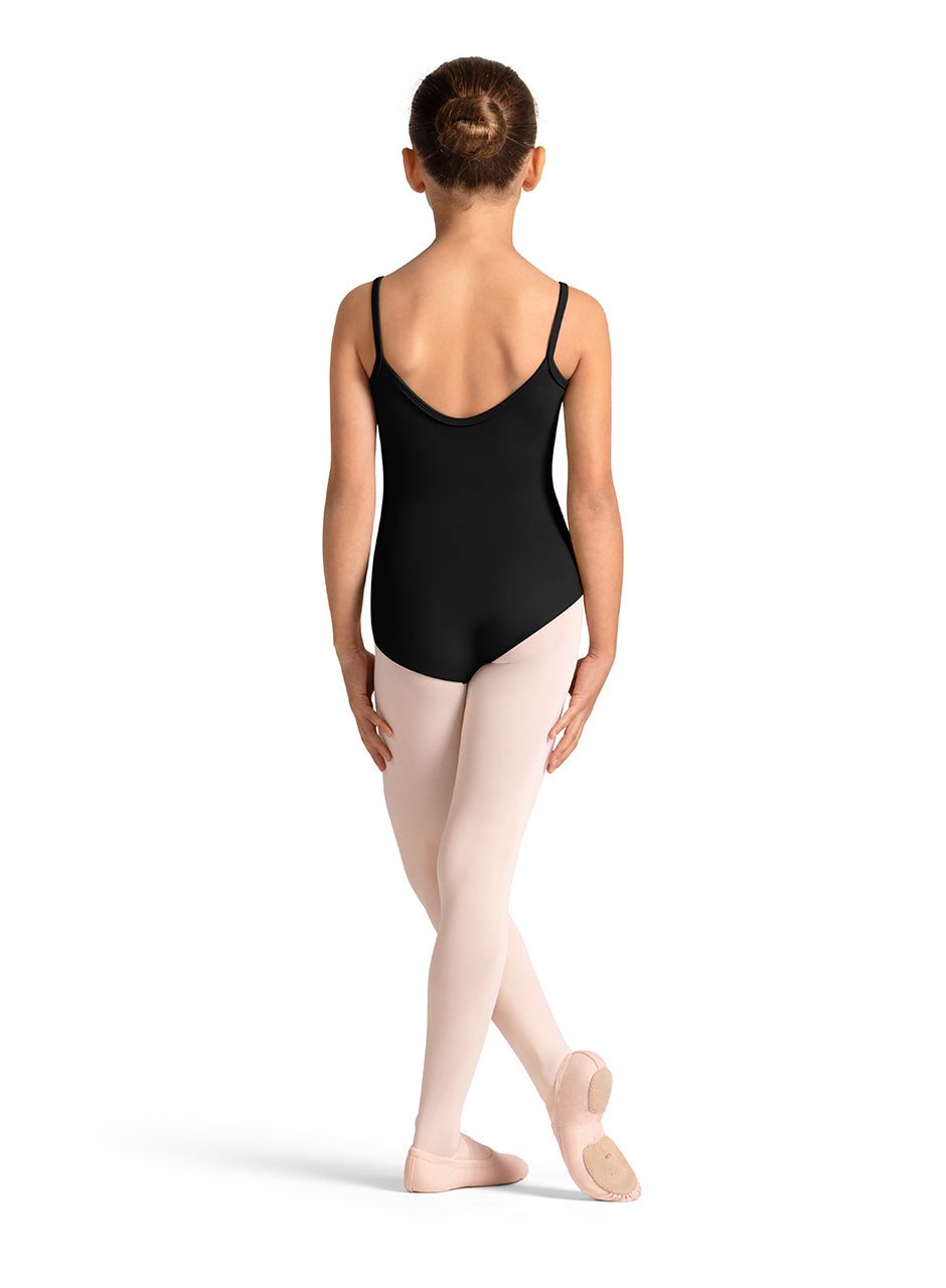 Person wearing a black leotard and beige tights on a white background