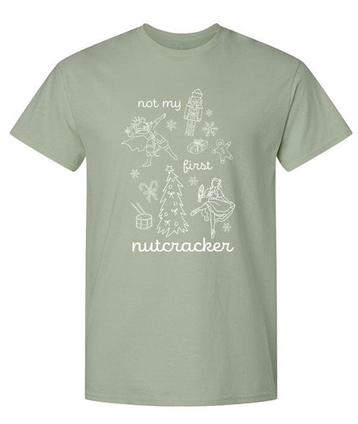 Sage green t-shirt with white 'not my first nutcracker' graphic design on a white background