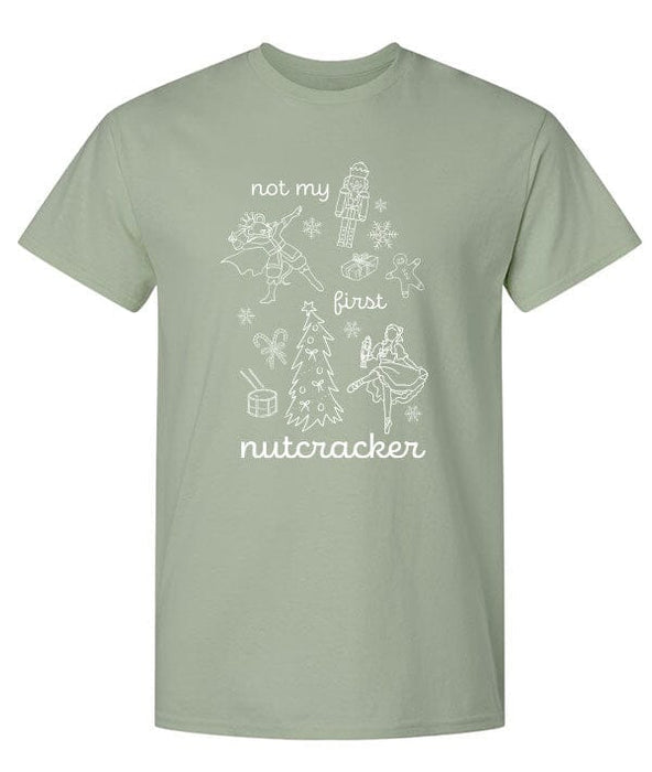 Sage green t-shirt with white 'not my first nutcracker' graphic design on a white background
