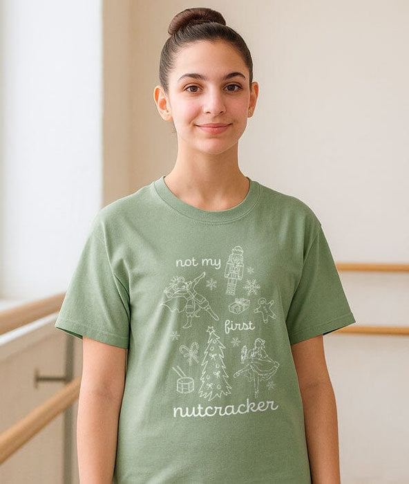 Person wearing a green t-shirt with a graphic design and text.