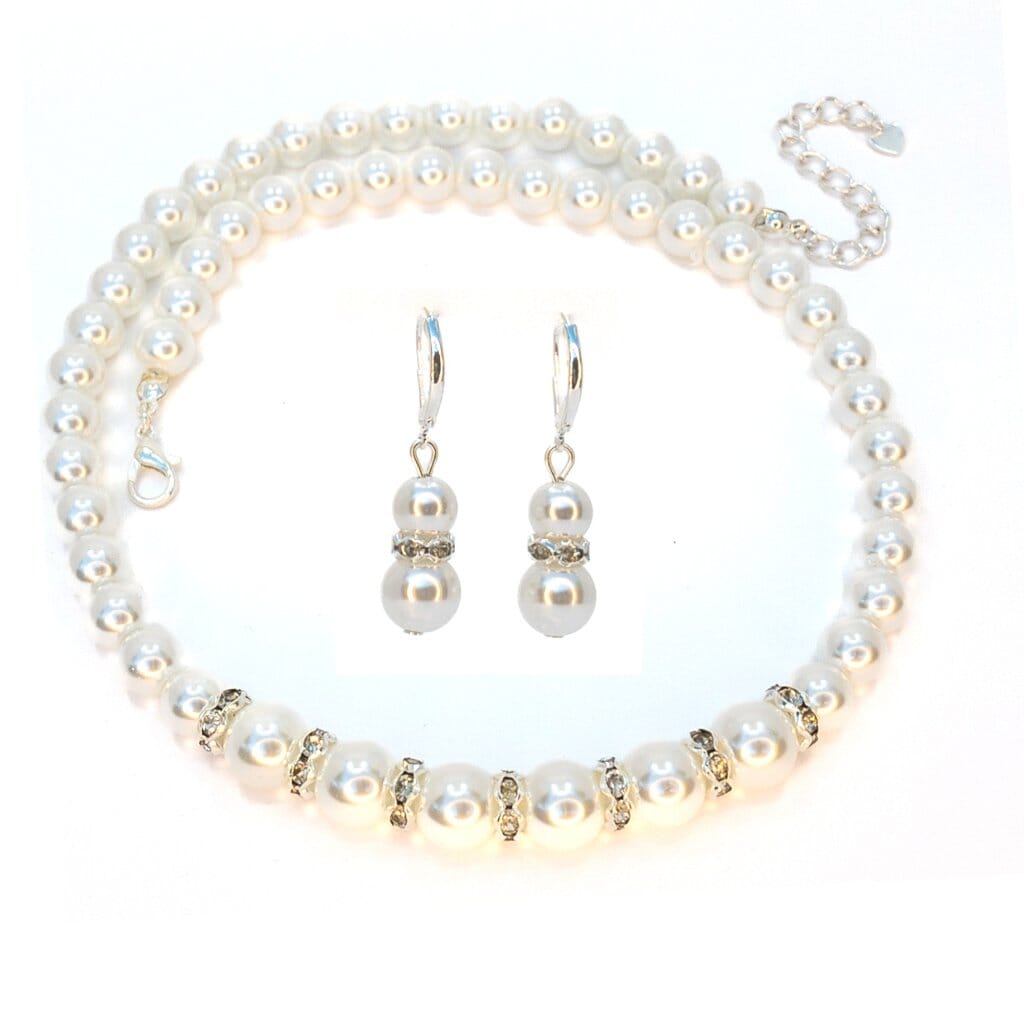Pearl necklace and earrings set on a white background
