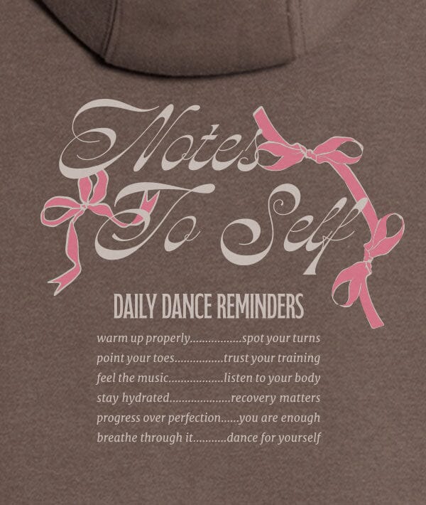 Brown sweatshirt with 'Notes to Self' text and pink ribbons on a brown background