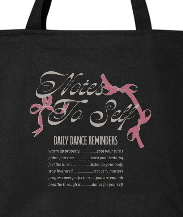 Black tote bag with 'Notes to Self' text and pink ribbons on a white background