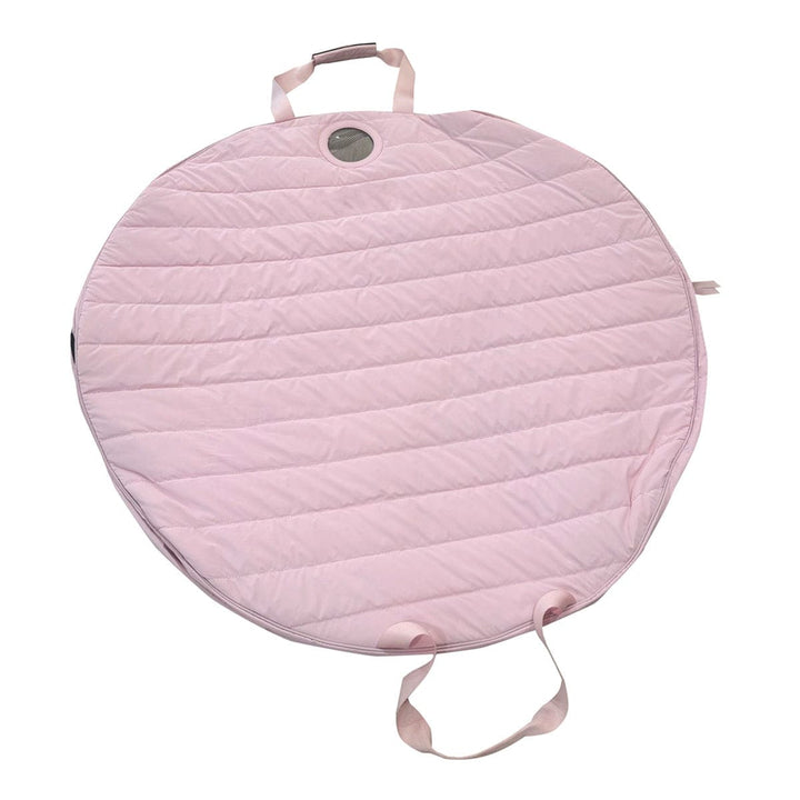 Pink quilted bag with a handle on a white background