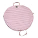 Pink quilted bag with a handle on a white background
