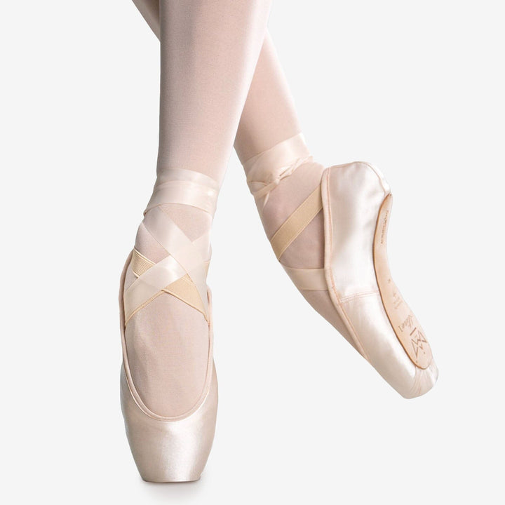 Ballet shoes with ribbons on a white background