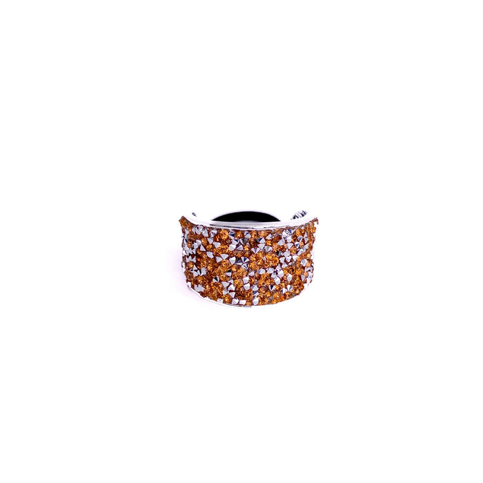 Silver ring with orange gemstones on a white background